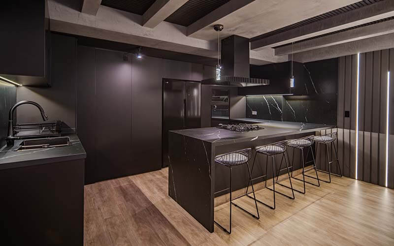 Modern black kitchen with waterfall counter