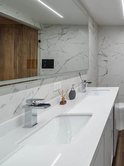 Bathroom with double vanity, walk-in shower, and sauna