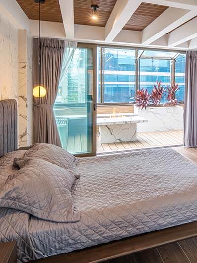 Bedroom with TV and sliding door to terrace